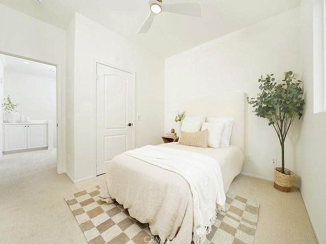 bedroom featuring light carpet, baseboards, and ceiling fan