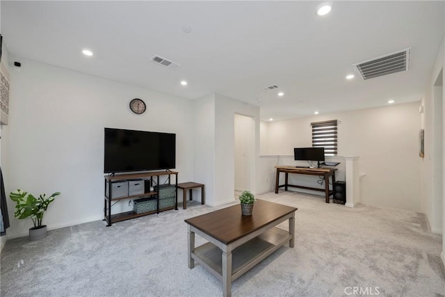 living area with recessed lighting, visible vents, and light colored carpet