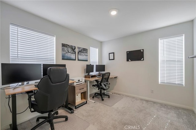 home office featuring baseboards and light carpet