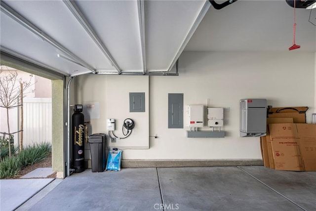 garage featuring electric panel and fence