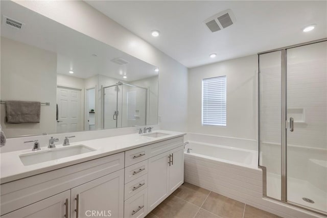 bathroom featuring a sink, visible vents, a bath, and a shower stall