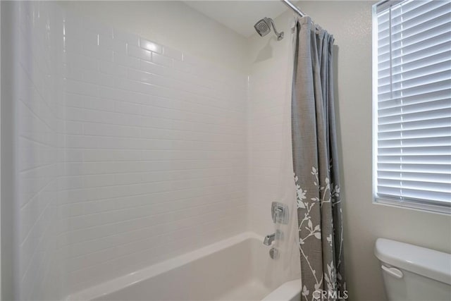 bathroom with toilet and shower / tub combo