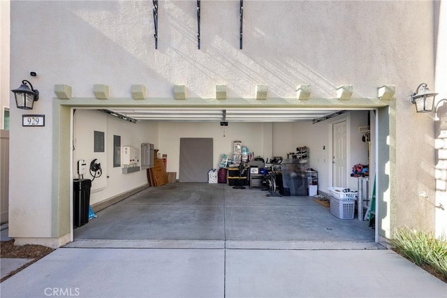 garage featuring concrete driveway