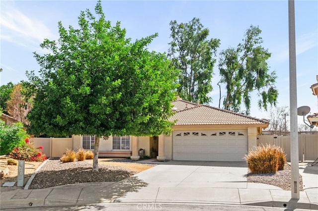 view of front of house featuring fence, stucco siding, concrete driveway, a garage, and a tiled roof