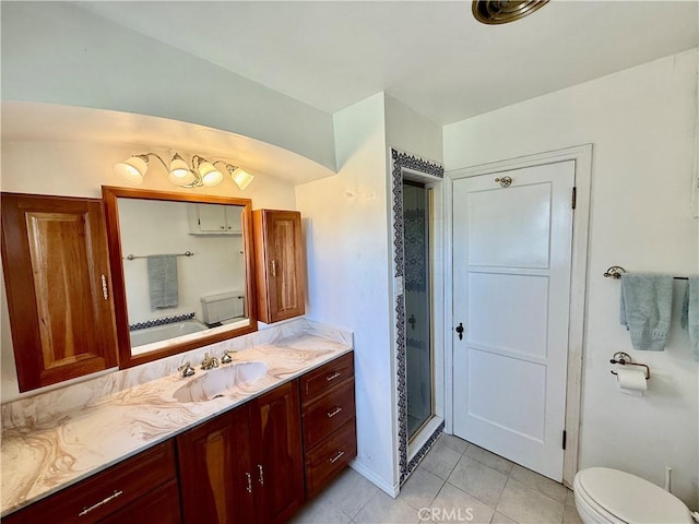 bathroom with toilet, a shower stall, vanity, and tile patterned flooring