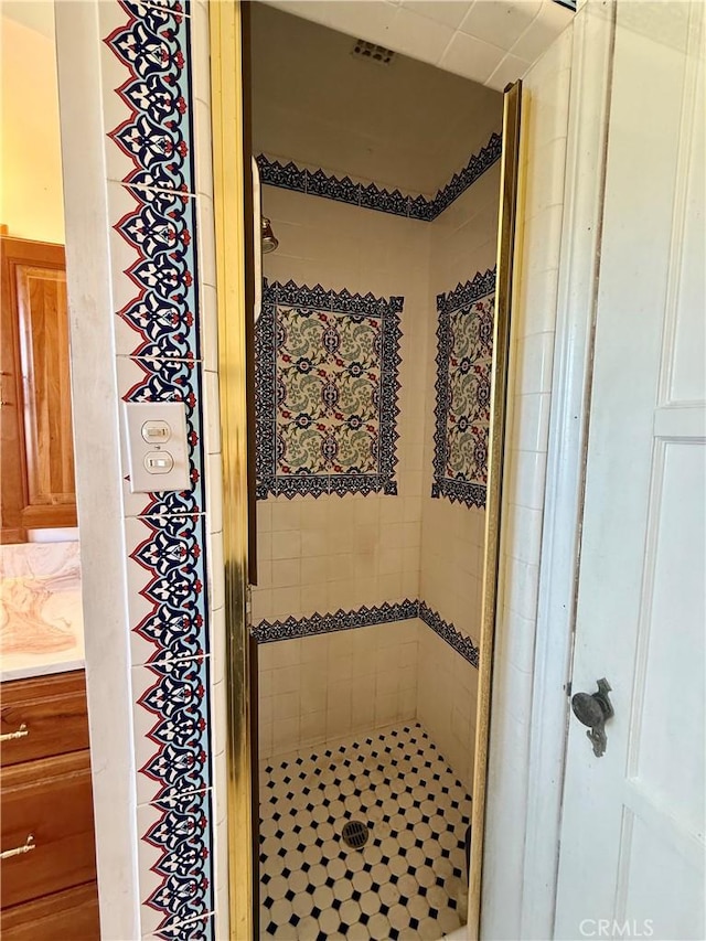 full bathroom with a stall shower and vanity