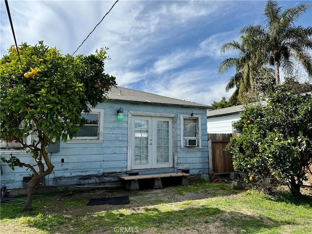 rear view of property featuring cooling unit, french doors, and fence