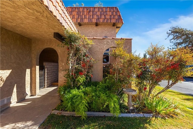 view of home's exterior featuring a tiled roof and stucco siding