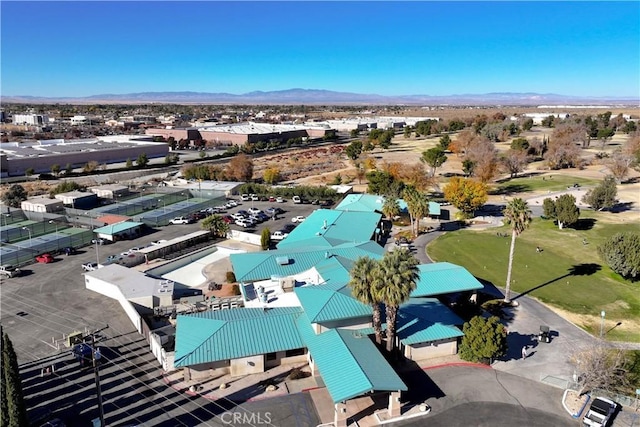 aerial view with a mountain view and view of golf course