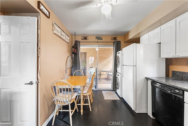 kitchen with white cabinetry, dark wood-style flooring, freestanding refrigerator, stacked washer / drying machine, and dishwasher