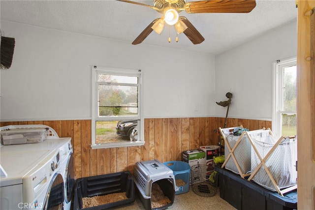 laundry room with laundry area, wainscoting, washer and dryer, and wooden walls