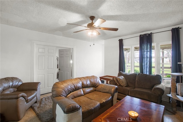 living area with a textured ceiling and ceiling fan