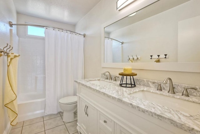 full bath featuring tile patterned flooring, double vanity, toilet, and a sink