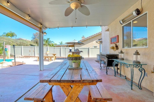 view of patio featuring outdoor dining area, a ceiling fan, and fence