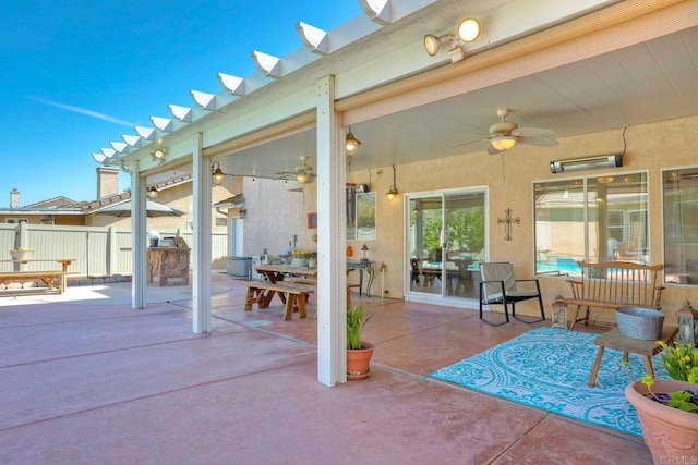 view of patio / terrace with a ceiling fan and fence