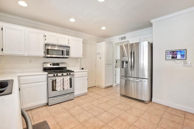 kitchen featuring visible vents, light countertops, ornamental molding, appliances with stainless steel finishes, and white cabinets