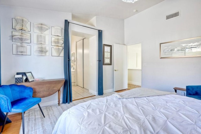 bedroom featuring light wood-style floors, baseboards, and visible vents