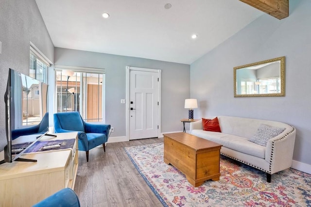 living area with recessed lighting, light wood-type flooring, baseboards, and vaulted ceiling