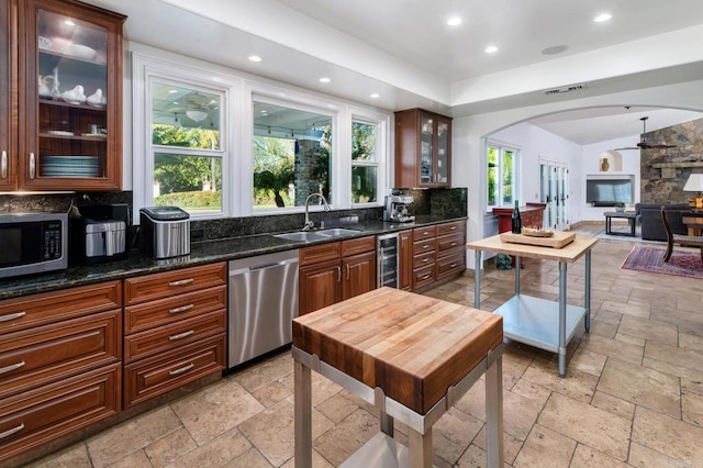 35715 Calle Nopal, Temecula, CA 92592 - kitchen featuring appliances with stainless steel finishes, stone tile floors, arched walkways, tasteful backsplash, and recessed lighting