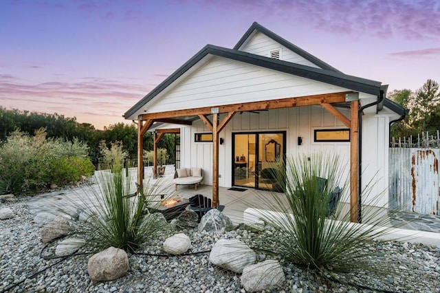 35715 Calle Nopal, Temecula, CA 92592 - rear view of property featuring an outdoor fire pit, board and batten siding, and a wooden deck