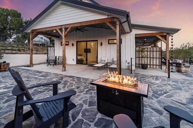 35715 Calle Nopal, Temecula, CA 92592 - patio terrace at dusk featuring a fire pit, a ceiling fan, and a patio area
