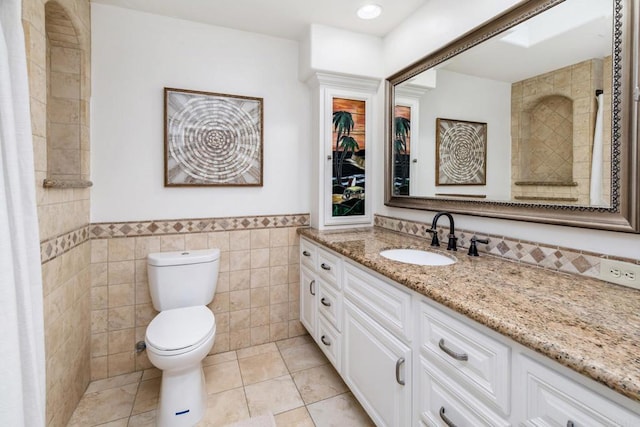 35715 Calle Nopal, Temecula, CA 92592 - bathroom featuring tile walls, vanity, and a wainscoted wall