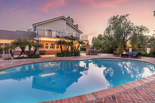 35715 Calle Nopal, Temecula, CA 92592 - pool at dusk featuring a patio area, an outdoor pool, and an outdoor living space with a fire pit