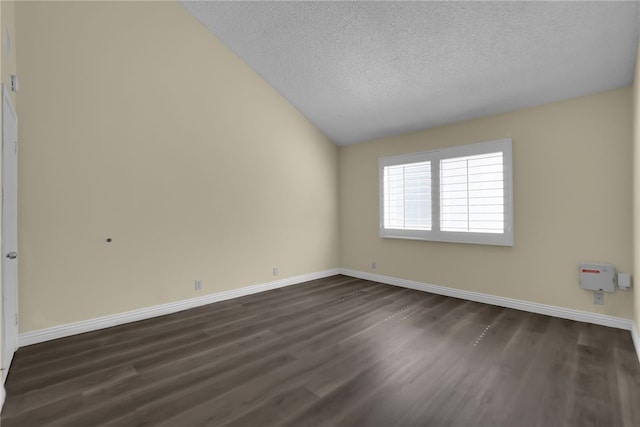 unfurnished room with dark wood finished floors, baseboards, a textured ceiling, and lofted ceiling