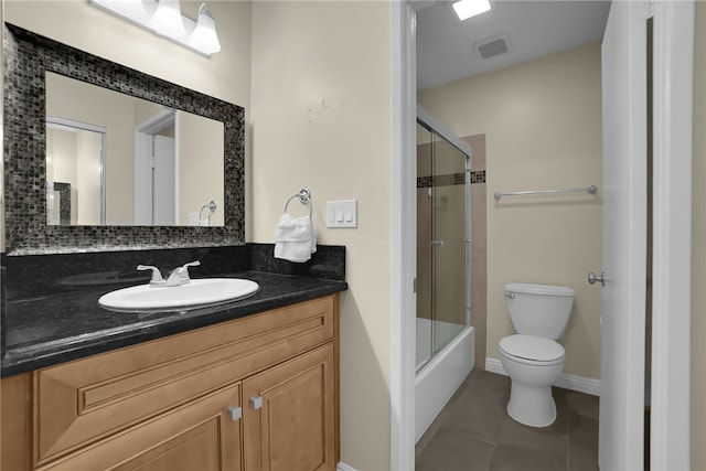 bathroom featuring vanity, baseboards, visible vents, tile patterned floors, and toilet