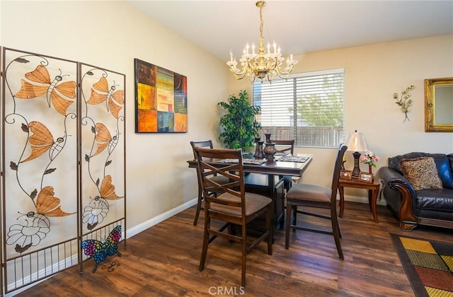 dining room with baseboards, an inviting chandelier, and wood finished floors