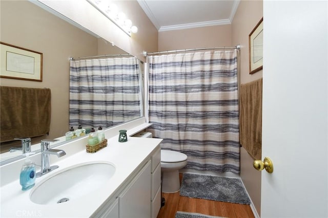 full bathroom featuring toilet, vanity, crown molding, and wood finished floors