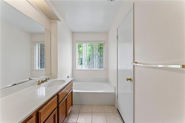 bathroom with vanity, tile patterned floors, and a garden tub