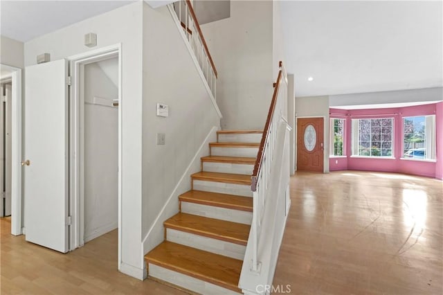 staircase featuring recessed lighting and wood finished floors