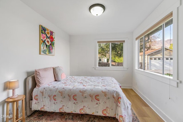 bedroom featuring wood finished floors and baseboards