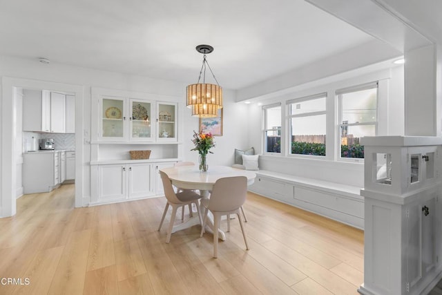 dining area with a chandelier and light wood finished floors