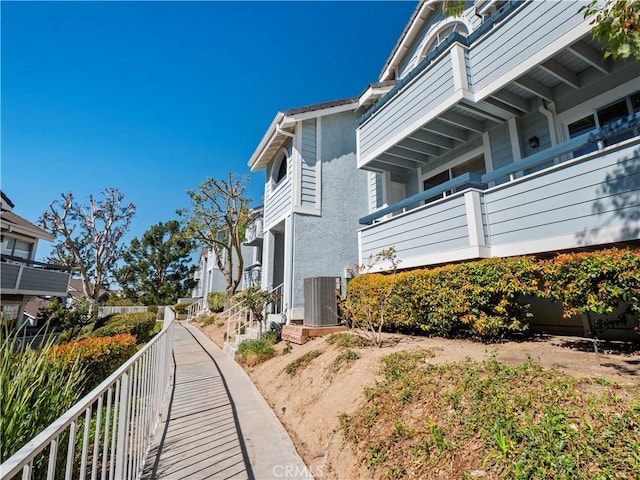 view of home's exterior with central air condition unit and stucco siding