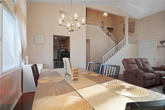 dining space featuring visible vents, a healthy amount of sunlight, stairs, and wood finished floors