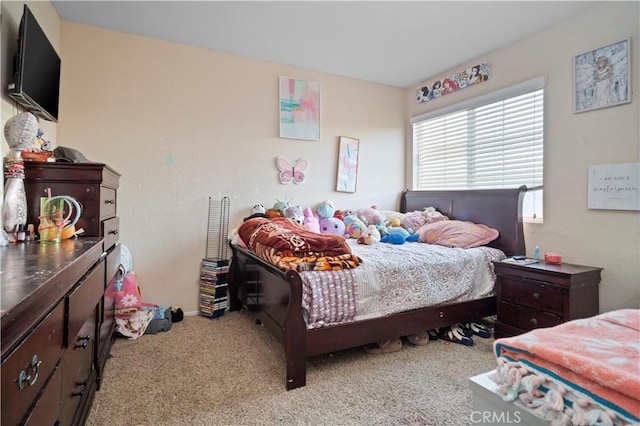 bedroom with baseboards and carpet