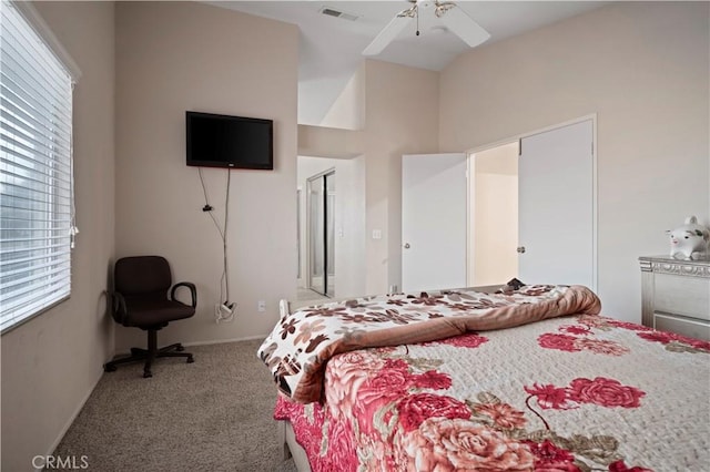 carpeted bedroom featuring multiple windows, a ceiling fan, visible vents, and baseboards