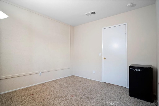 empty room featuring carpet and visible vents