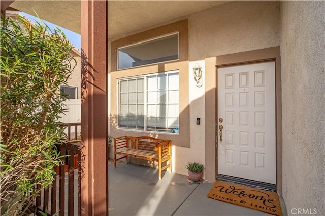 property entrance featuring stucco siding