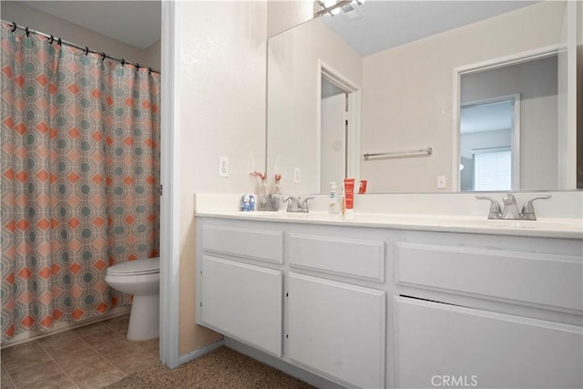 full bathroom featuring tile patterned floors, toilet, a sink, curtained shower, and double vanity