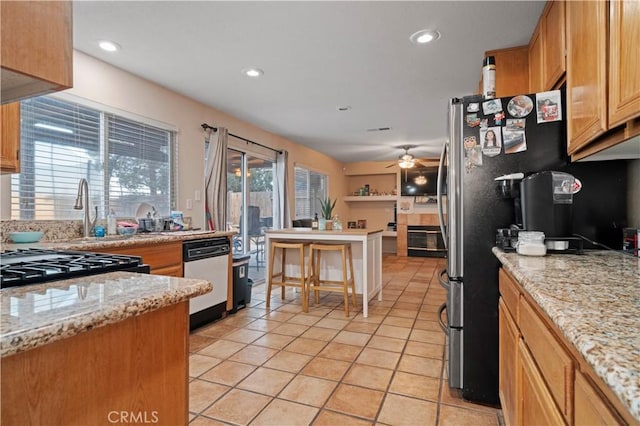 kitchen with light stone counters, light tile patterned floors, a ceiling fan, recessed lighting, and freestanding refrigerator