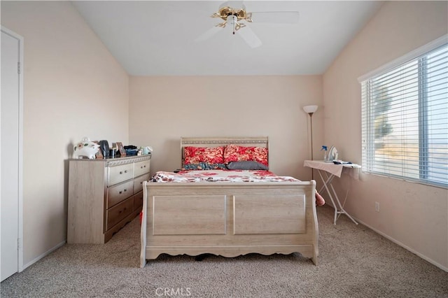 bedroom with light carpet, ceiling fan, baseboards, and lofted ceiling