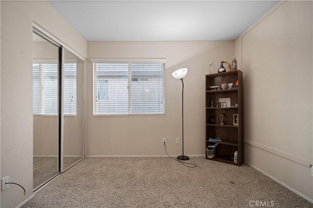 unfurnished bedroom featuring a closet and carpet floors