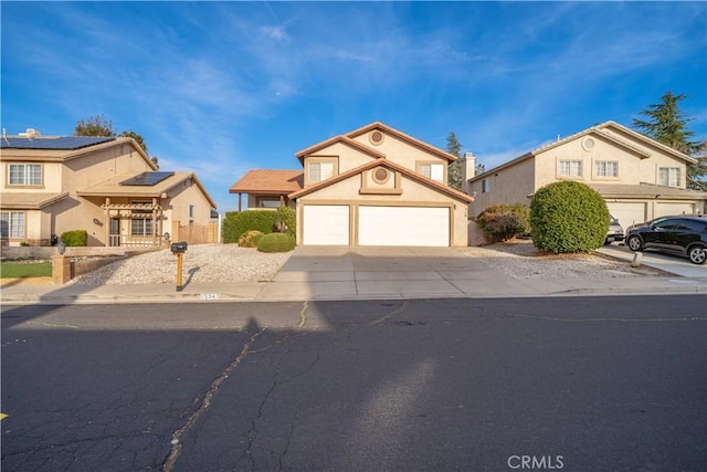 traditional-style home featuring a residential view, stucco siding, an attached garage, and concrete driveway