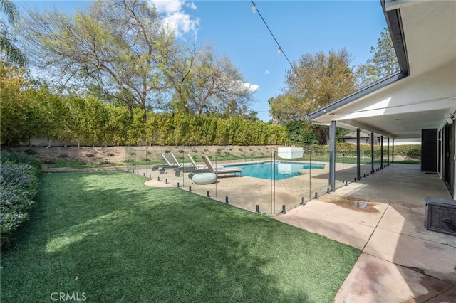 view of pool with a fenced in pool, a lawn, and a patio area