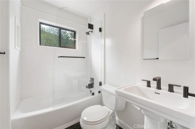 full bath with a sink, toilet, and bathing tub / shower combination