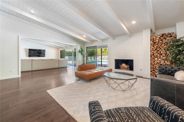 living area with a fireplace, vaulted ceiling with beams, wood finished floors, and baseboards