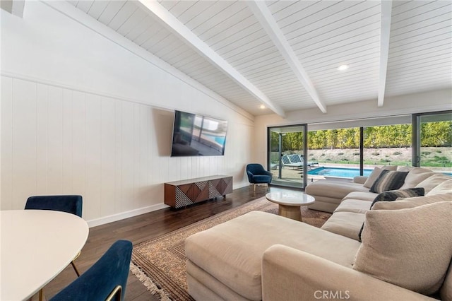 living area with lofted ceiling with beams, baseboards, and wood finished floors